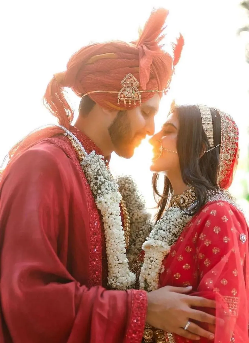 Happy Indian wedding couple smiling at each other during candid bridal photoshoot
