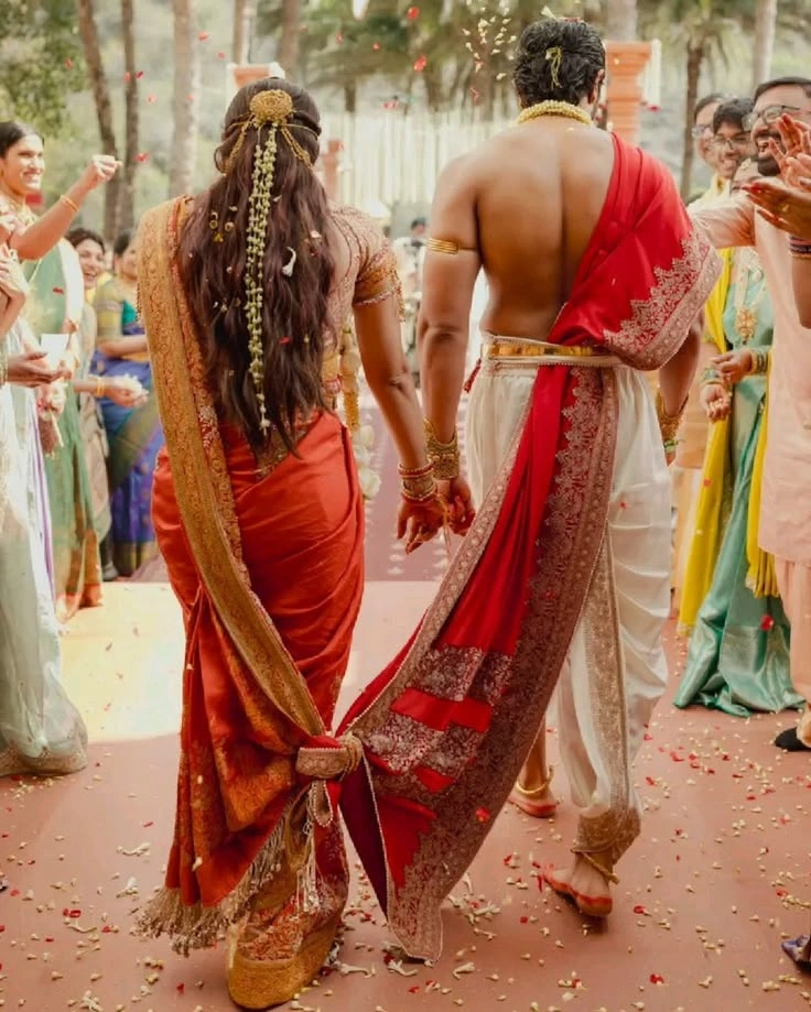 Bride and groom walking hand in hand in a stylish wedding aisle pose