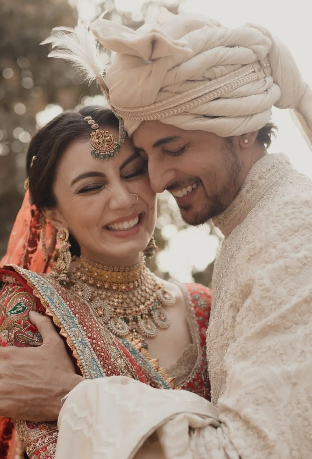 Romantic close-up pose of Indian bride and groom in traditional wedding outfits