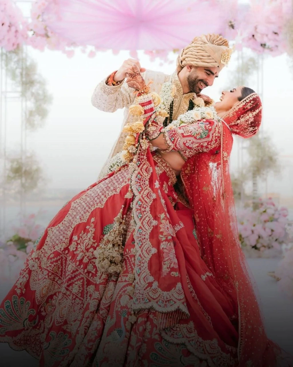 Bride and groom standing together in matching wedding outfits for classic wedding portrait
