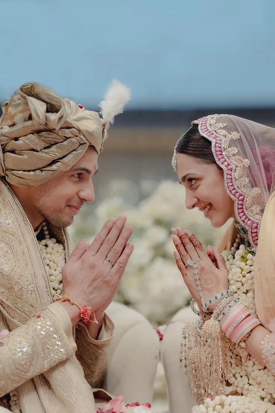 Bride and groom doing namaste pose in traditional Indian wedding ceremony