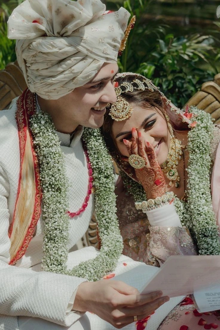 Bride resting her head on groom’s shoulder in a sweet Indian wedding portrait