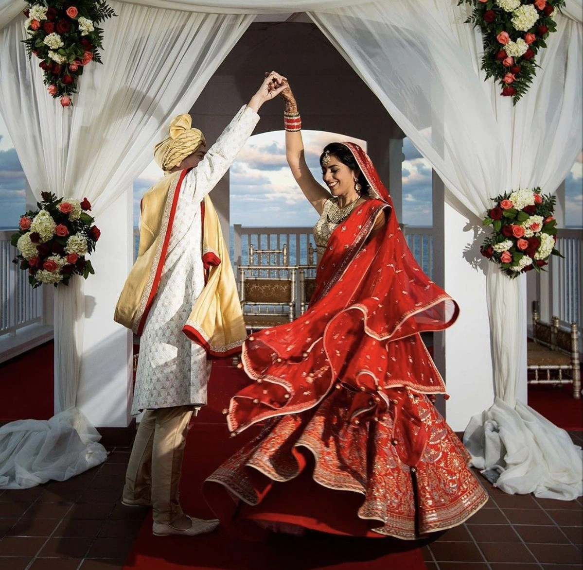 Groom twirling bride in lehenga during elegant Indian wedding photoshoot