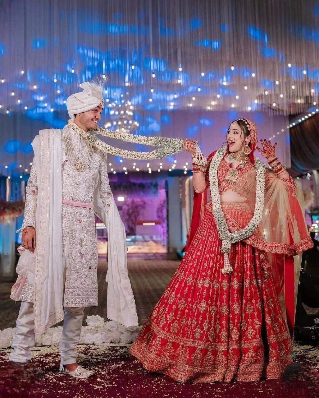 Candid Indian wedding couple laughing together in playful marriage photoshoot pose