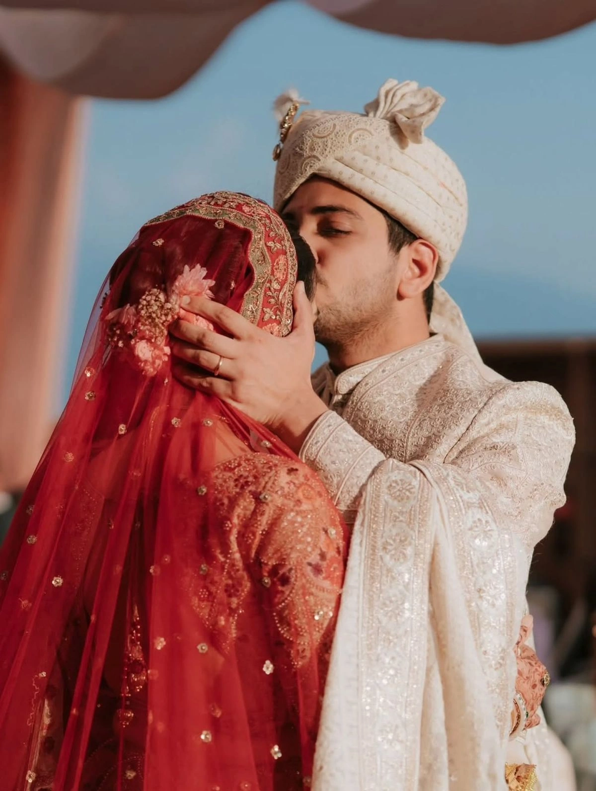 Dreamy sunset wedding pose of Indian bride and groom during golden hour shoot