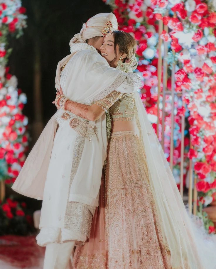 Bride and groom hugging warmly in a cute and emotional Indian wedding pose